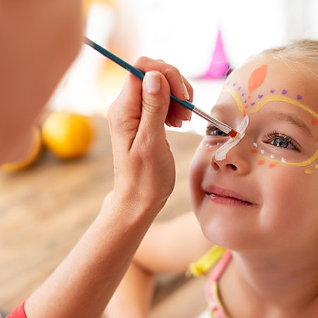 Child having their face painted at CPC Kid's Club